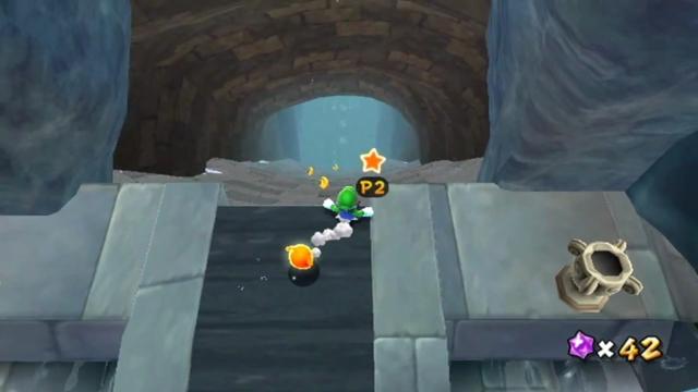 Luigi at the very top of a stone slide, looking down. (The player has switched to Luigi.)